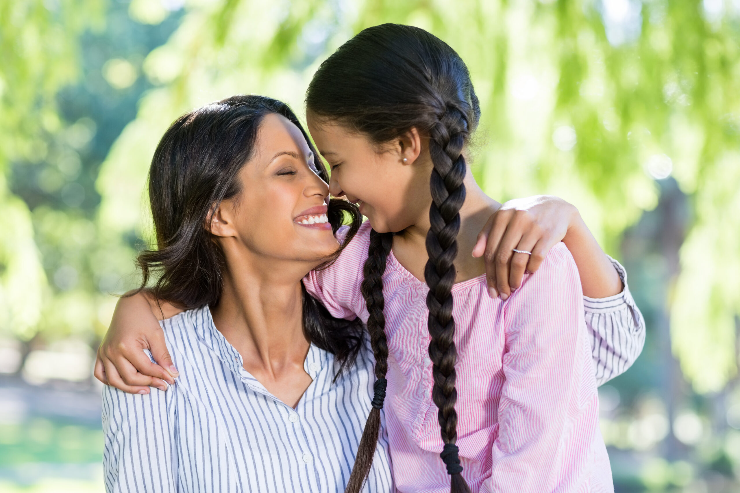 Mother and daughter smiling together, representing the supportive family care at Whole Child Collective