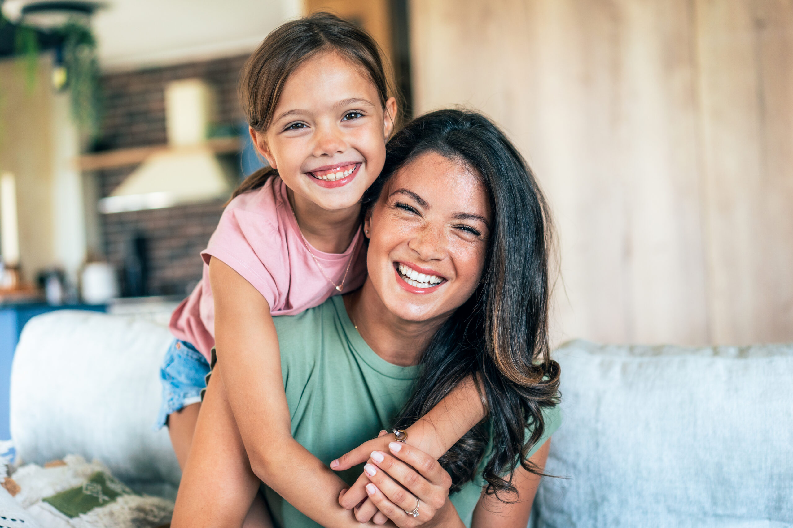 A mother and daughter sharing a joyful moment, representing the positive change families experience after getting the right answers and support through Whole Child Collective